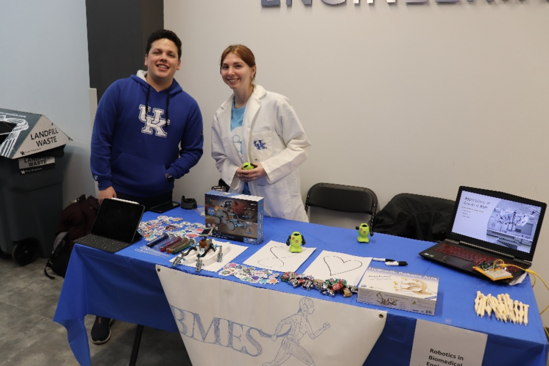 E-Day Robotics Event Prep. BMES President Trisha Sullivan and Andres Phillips setting up a table showcasing robots in biomedical engineering at the 100th E-Day.