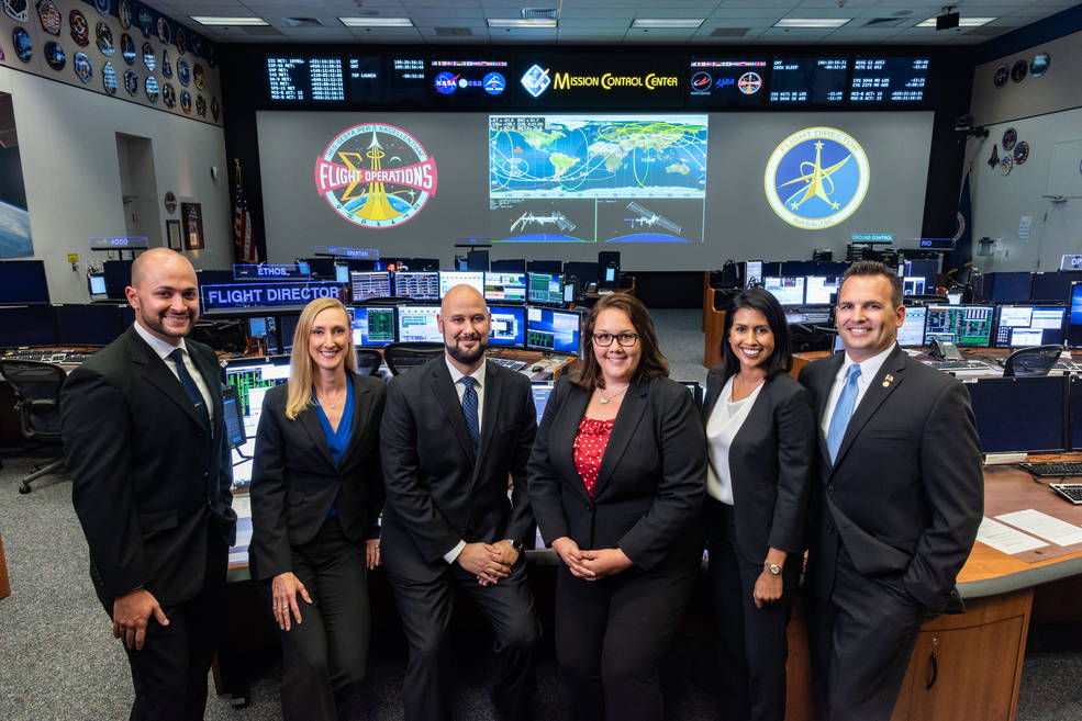 The 2018 Class of NASA Flight Directors for the Mission Control Center (L-R): Marcos Flores, Allison Bolinger, Adi Boulos, Rebecca Wingfield, Pooja Jesrani, and Paul Konyha. Credits: NASA/Robert Markowitz