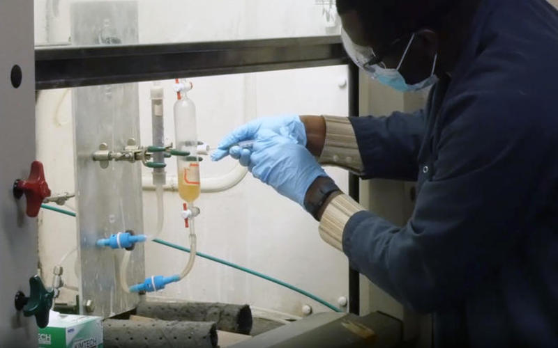 Reynolds Frimpong, senior research engineer at CAER, works on a carbon dioxide capture experiment.